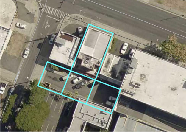 Aerial view showcasing commercial property with three parking lots.