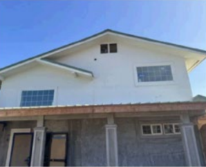 Exterior of mixed-use property in Wailuku HI with apartments and commercial unit