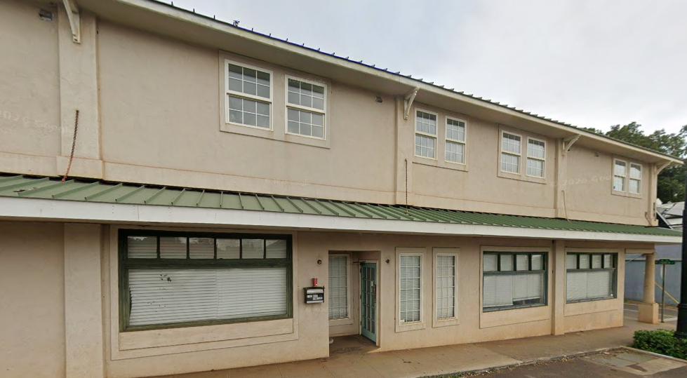 Exterior of mixed-use property in Wailuku HI with apartments and commercial unit